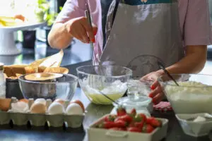 a woman attending a cooking class as part of her addiction recovery